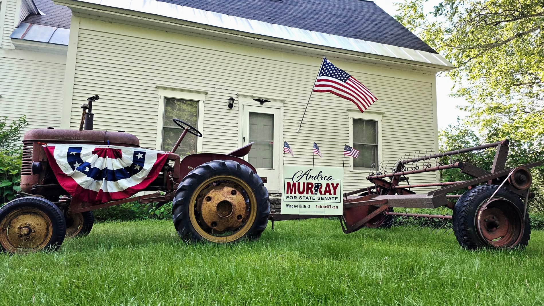 Andrea Murray campaign sign on a vintage tractor with American flags